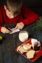 A boy writes a note to Santa and prepares a treat Royalty Free Stock Photo