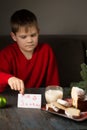 A boy writes a note to Santa and prepares a treat Royalty Free Stock Photo