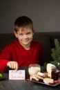 A boy writes a note to Santa and prepares a treat Royalty Free Stock Photo