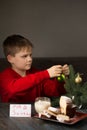 A boy writes a note to Santa and prepares a treat Royalty Free Stock Photo