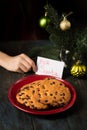 A boy writes a note to Santa and prepares a treat Royalty Free Stock Photo