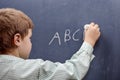 Boy writing alphabet