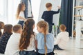 Boy writing on the board. Group of children students in class at school with teacher Royalty Free Stock Photo