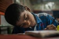 Boy writing during the classroom in India