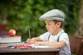 Boy, writing his homework from school, drawing and writing in hi Royalty Free Stock Photo