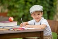 Boy, writing his homework from school, drawing and writing in hi Royalty Free Stock Photo