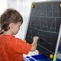 Boy writing letters learning procces son smart child Royalty Free Stock Photo