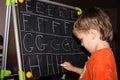 Boy writing letters learning process knowledge of small child Royalty Free Stock Photo