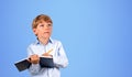 Boy writing in notebook with pen, blue Royalty Free Stock Photo