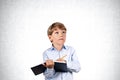 Boy writing in notebook with pen, concrete Royalty Free Stock Photo