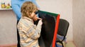 Boy writing something on blackboard Royalty Free Stock Photo