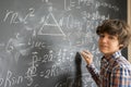 Boy writting on black board Royalty Free Stock Photo