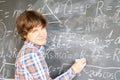 Boy writting on black board Royalty Free Stock Photo