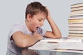 Boy yawns over homework Royalty Free Stock Photo