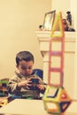 The boy 2 years building a tower from a bright constructor. little smiling boy playing with magnetic constructor toy. Boy playing Royalty Free Stock Photo