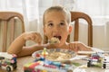 The boy 4years eats porridge. Children& x27;s table. The concept of the child& x27;s independence. happy little boy eating