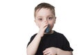 Boy 4 years old inhales himself on a white background