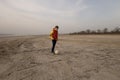 A boy of 10 years old plays soccer on an empty beach. Royalty Free Stock Photo