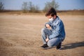 A boy of 8-9 years old in a protective mask and jeans clothes outdoors Royalty Free Stock Photo