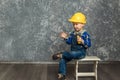 The boy in yellow hard hat holding a hammer Royalty Free Stock Photo