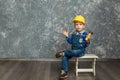 The boy in yellow hard hat holding a hammer Royalty Free Stock Photo