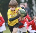 Boy with yellow jacket play rugby Royalty Free Stock Photo