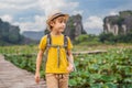 Boy in a yellow on the path among the lotus lake. Mua Cave, Ninh Binh, Vietnam. Vietnam reopens after quarantine Royalty Free Stock Photo