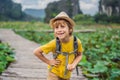 Boy in a yellow on the path among the lotus lake. Mua Cave, Ninh Binh, Vietnam. Vietnam reopens after quarantine Royalty Free Stock Photo