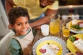 Boy with yogurt moustache having dinner