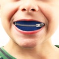 Little boy with zipper in mouth