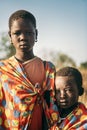 BOYA TRIBE, SOUTH SUDAN - MARCH 10, 2020: Children from Boya Tribe wearing pieces of bright fabric and looking at camera while