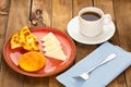 Boyacense breakfast with arepa, cheese, almojabana and aguapanela