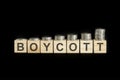 boycott - word of wooden blocks with letters on a black background. selective focus.