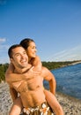 Boyfriend carrying girlfriend at beach