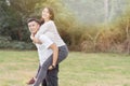 Boyfriend carrying his girlfriend on piggyback Royalty Free Stock Photo