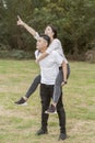 Boyfriend carrying his girlfriend on piggyback Royalty Free Stock Photo