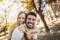 Boyfriend carrying his girlfriend on piggyback Royalty Free Stock Photo