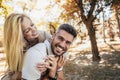 Boyfriend carrying his girlfriend on piggyback Royalty Free Stock Photo