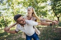 Boyfriend carrying his girlfriend on piggyback Royalty Free Stock Photo