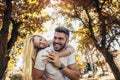 Boyfriend carrying his girlfriend on piggyback Royalty Free Stock Photo