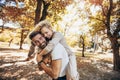 Boyfriend carrying his girlfriend on piggyback Royalty Free Stock Photo