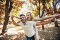 Boyfriend carrying his girlfriend on piggyback Royalty Free Stock Photo