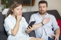 Boyfriend caught by girlfriend while cheating with mobile phone Royalty Free Stock Photo