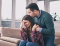 Boyfriend consoling crying girl at home