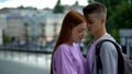 Boyfriend getting closer hugging girlfriend, date outdoors, couple in love Royalty Free Stock Photo