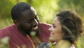 Boyfriend and girlfriend laughing on romantic date outside of city, soulmates