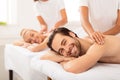 Boyfriend And Girlfriend Lying Enjoying Relaxing Massage At Spa Resort