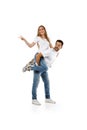 Boyfriend giving piggyback to girlfriend on white background Royalty Free Stock Photo