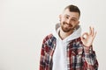 Boyfriend has everything under control. Portrait of pleased assuring good-looking guy with beard and flesh tunnels