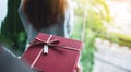 Boyfriend holding a gift box behind his girlfriend back to surprising her Royalty Free Stock Photo